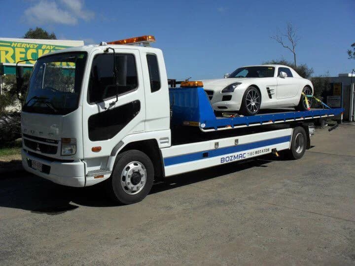 24/7 emergency towing in Melbourne with a Southern Towing flatbed truck transporting a white sports car